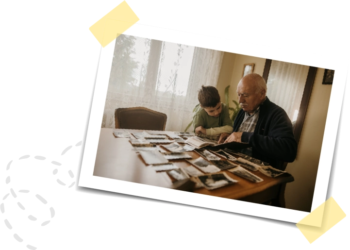 grandpa and grandson looking at photo album together
